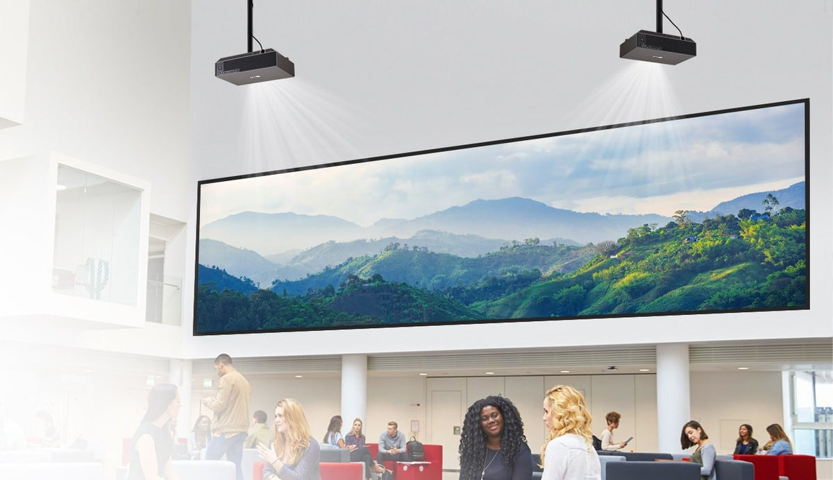 Two LG ProBeam projectors projecting a wide image in a bright atrium