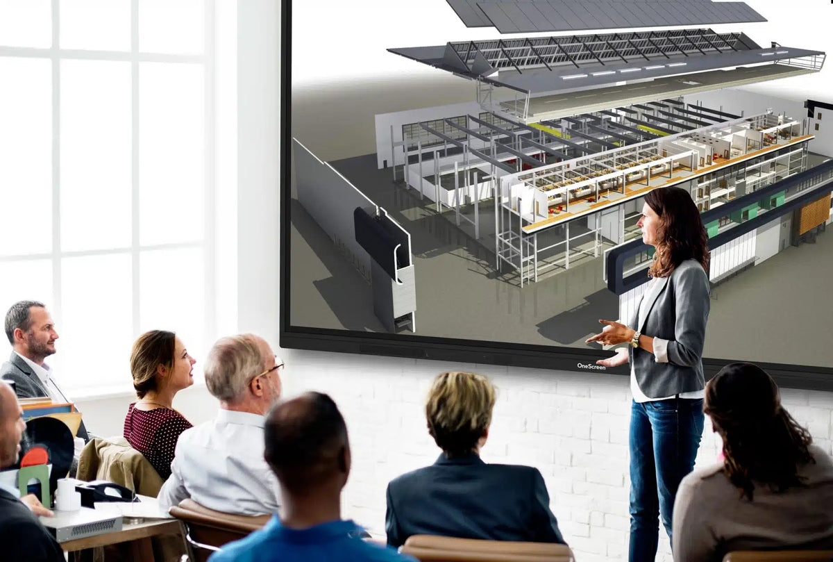Presenter explaining a 3D building model on a OneScreen interactive display in a briefing room