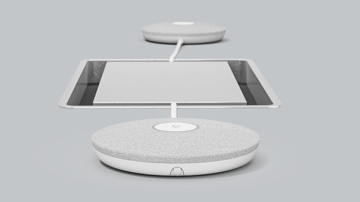 Two Logitech Rally Mic Pods connected by cable on a meeting table
