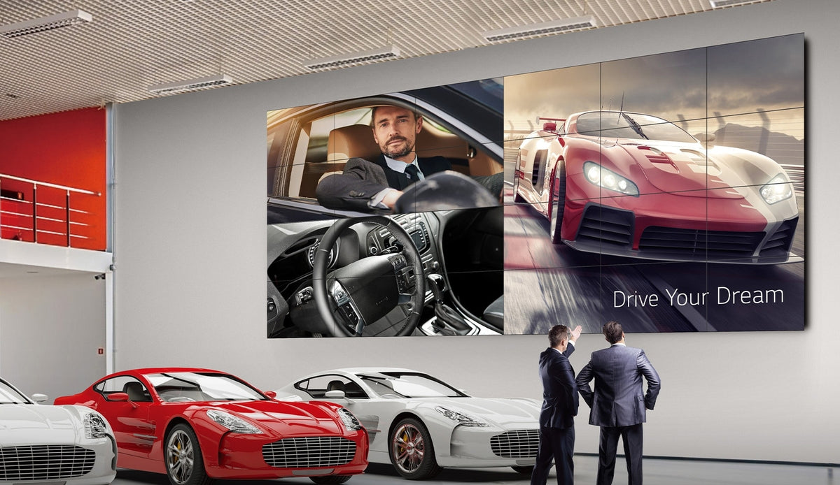 LG 55VM5J-H video wall above sports cars in a car showroom
