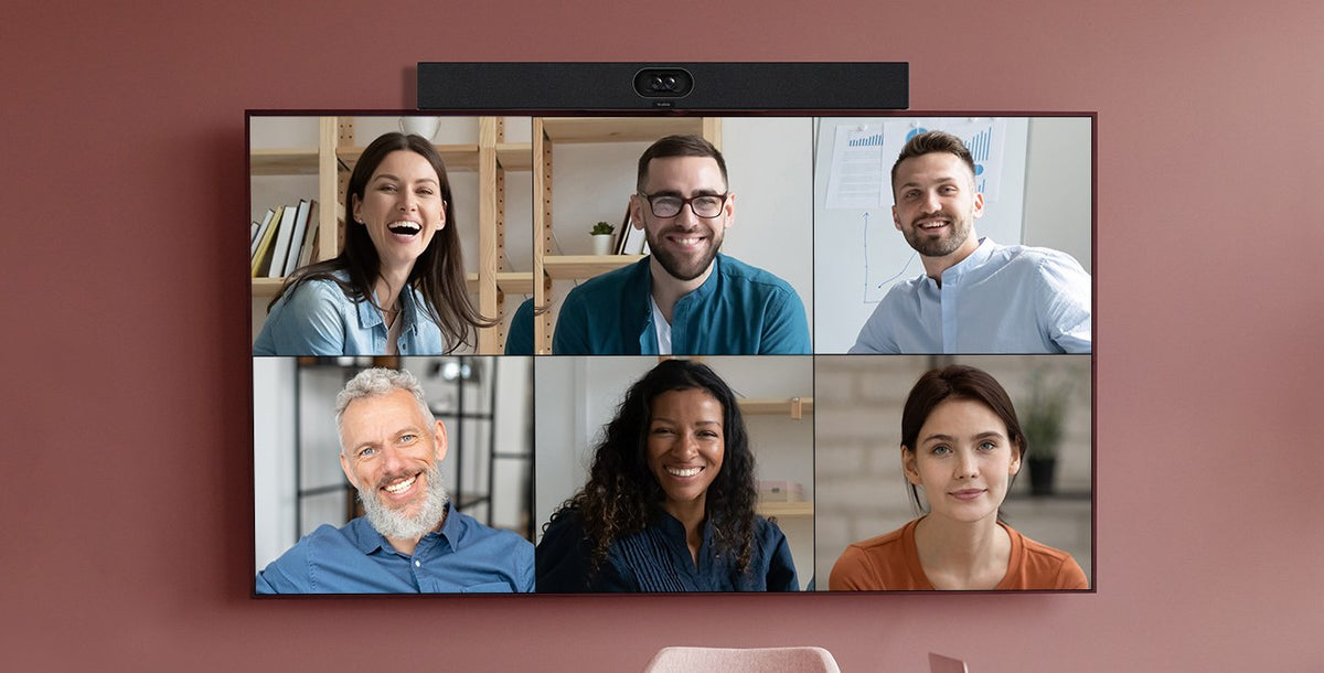 Yealink SmartVision 40 camera bar above a wall display showing six remote participants