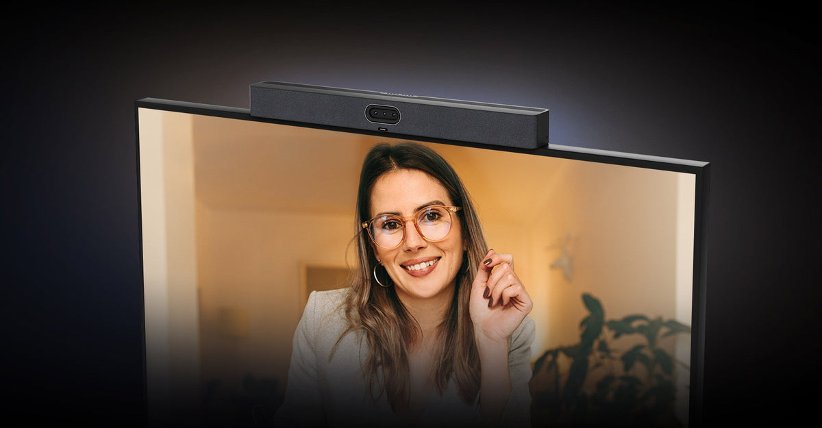 Yealink MeetingBar A50 on top of a display showing a remote participant