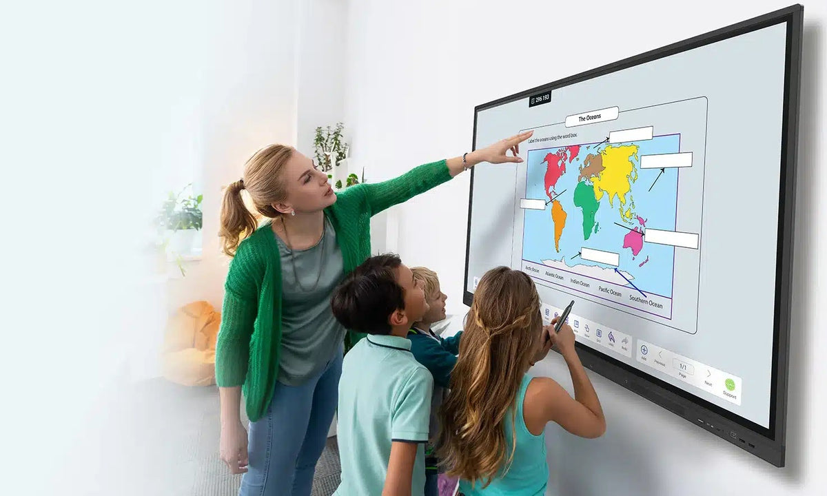 Teacher and children pointing at a world map on a OneScreen TL7 touchscreen