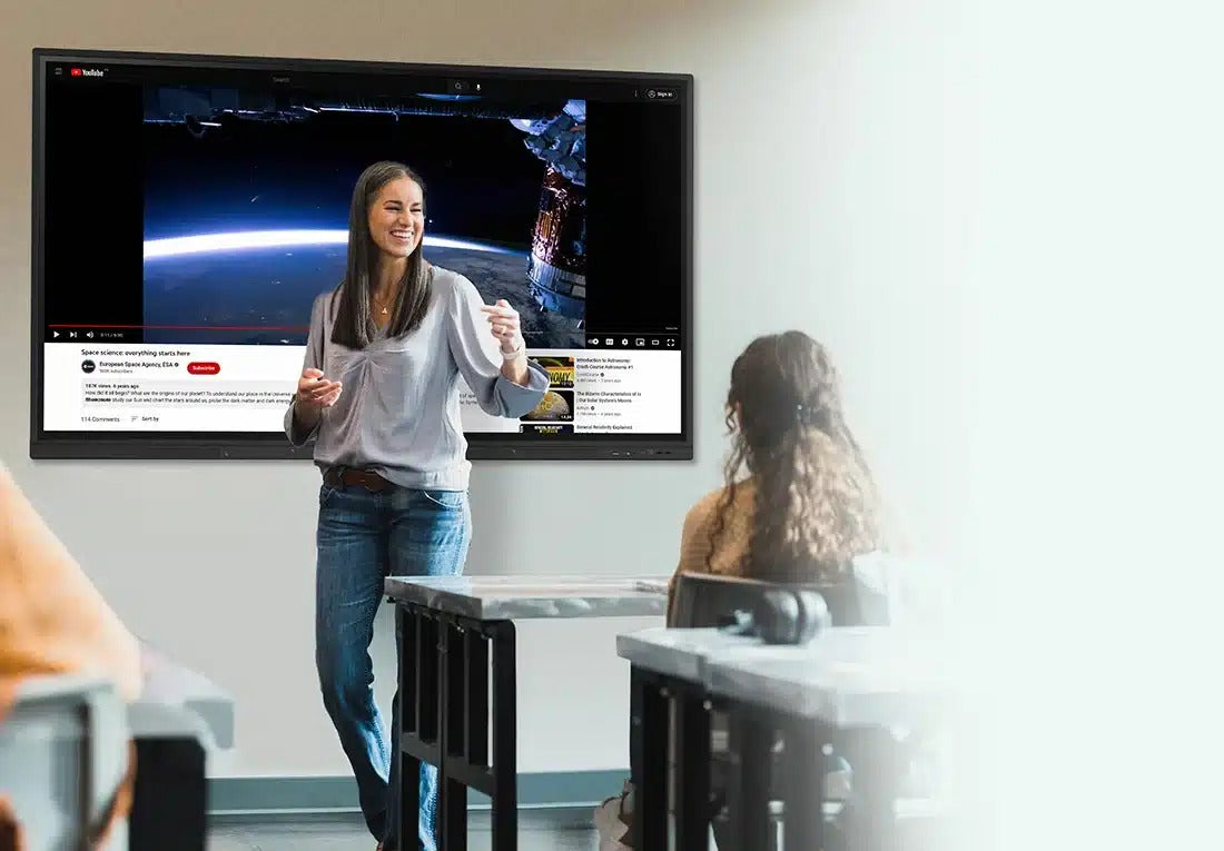 Teacher presenting a space video on a OneScreen TL7 to a class