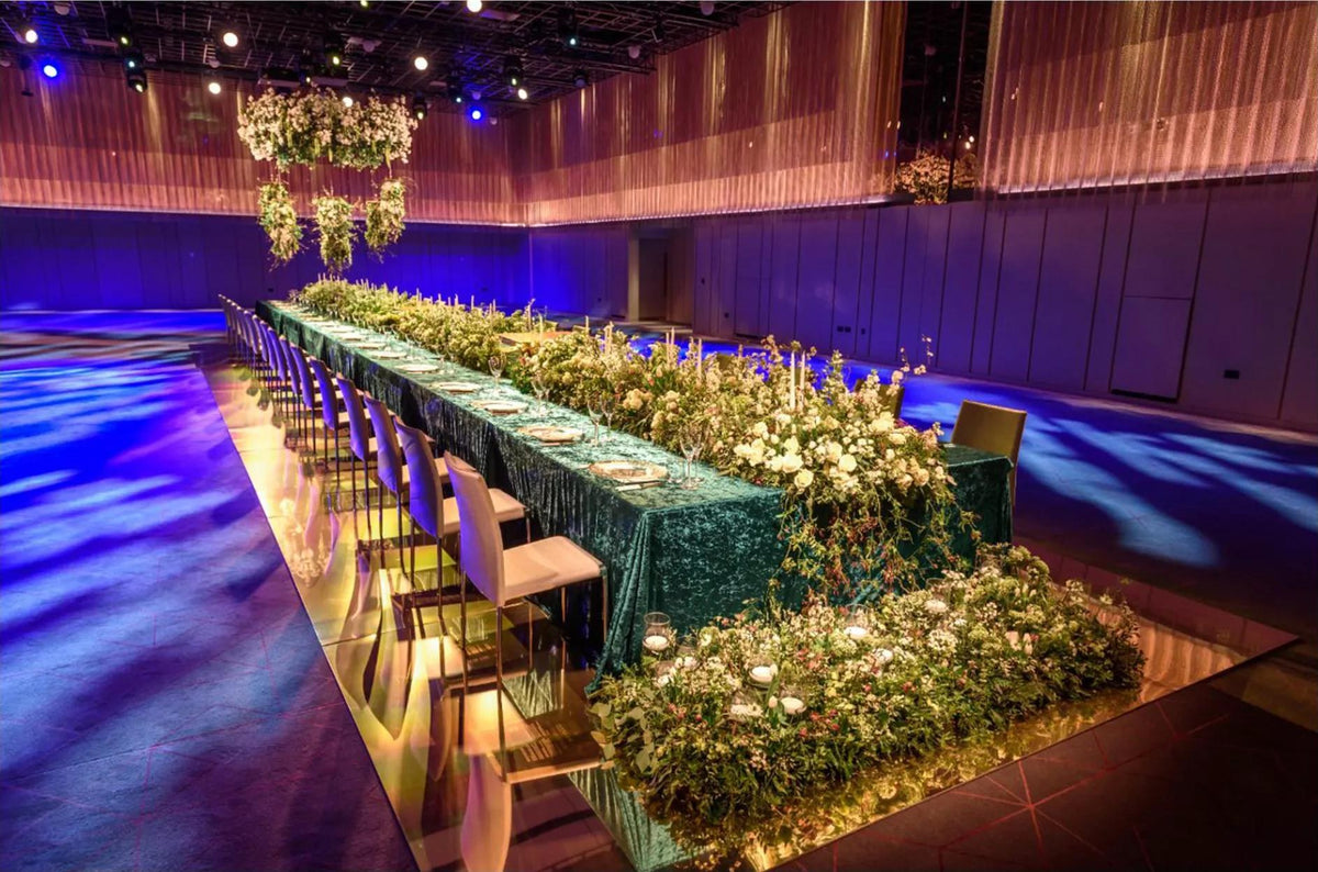Hospitality event hall with a long dining table set for a dinner