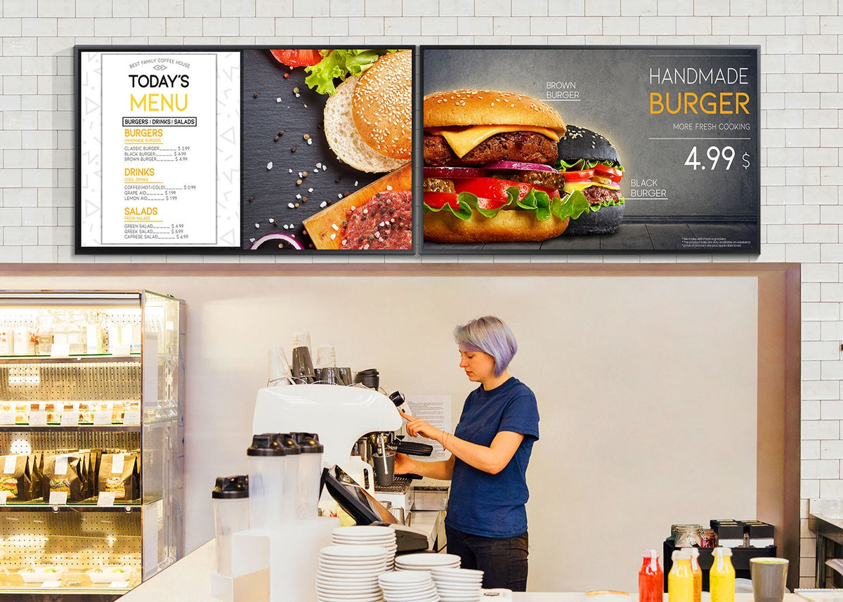 Samsung QBN signage displays used as menu boards above a cafe counter