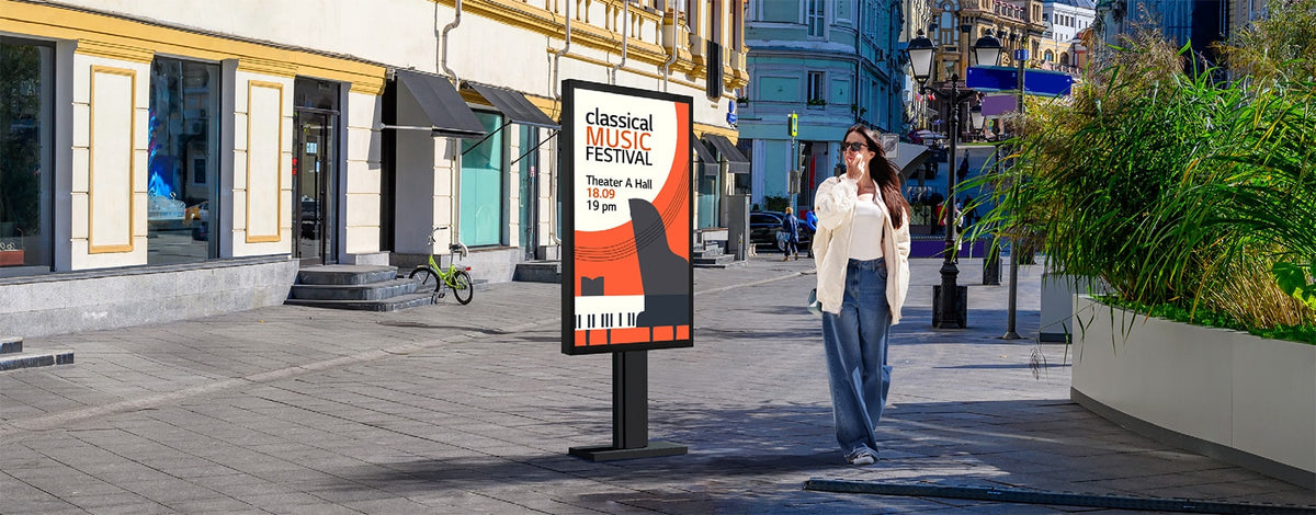 LG XE3P outdoor display on a sunny street with a passer-by