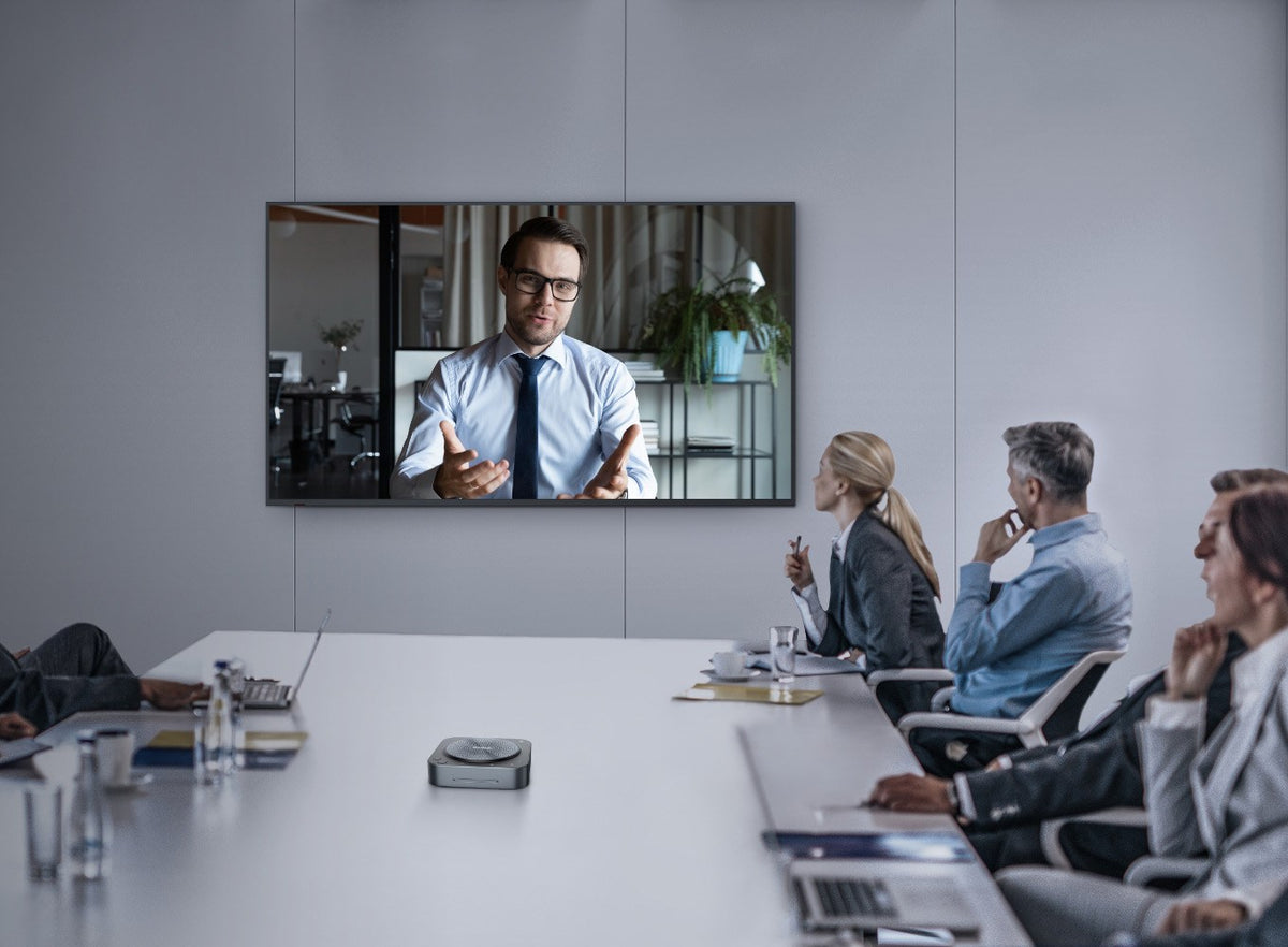 MAXHUB UC BM35 speakerphone in the centre of a boardroom table during a video call