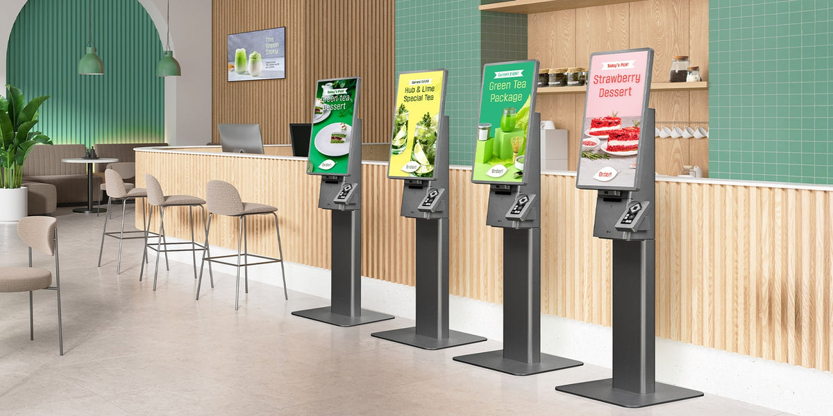 Row of LG 27KC3P-M self-service kiosks on floor stands in a restaurant