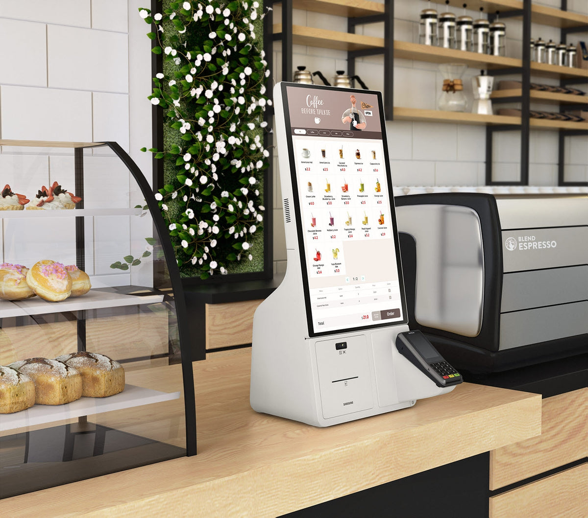 Samsung KM24A kiosk with a card terminal on a cafe counter