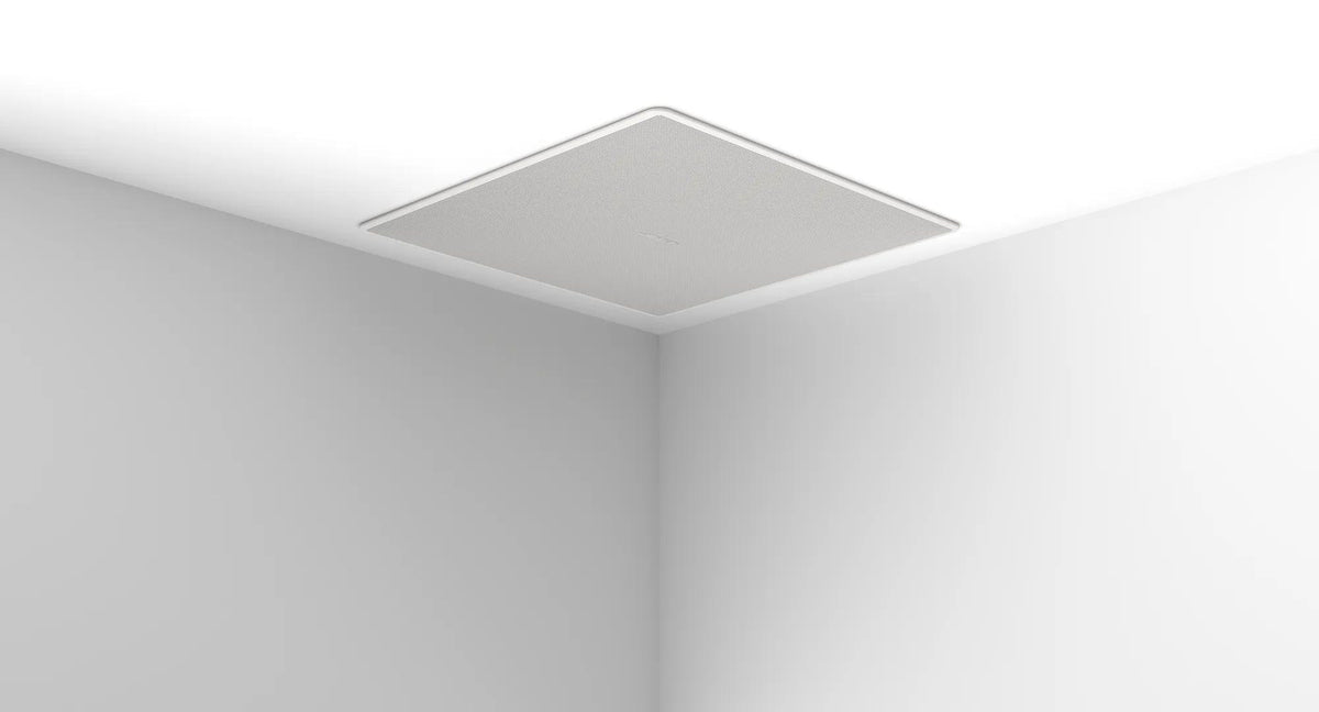 Bose EdgeMax loudspeaker installed at the edge of a ceiling near the corner of a room
